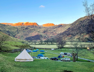 Scenic view of Sykeside Camping Park nestled in the Dovedale Valley, surrounded by Dove Crag, Hart Crag, and Fairfield